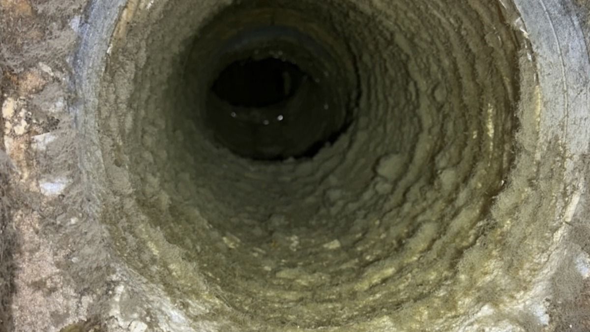 Flexible air duct with heavy buildup before professional cleaning