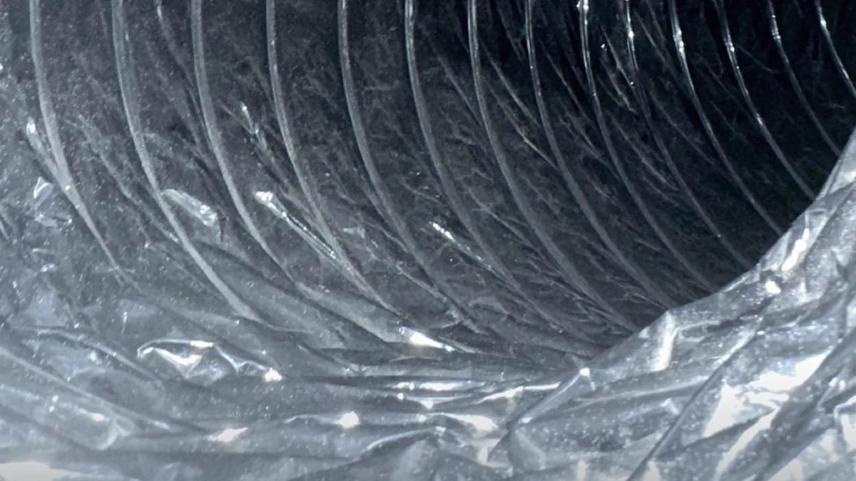 Same dark flexible air duct cleared after professional cleaning