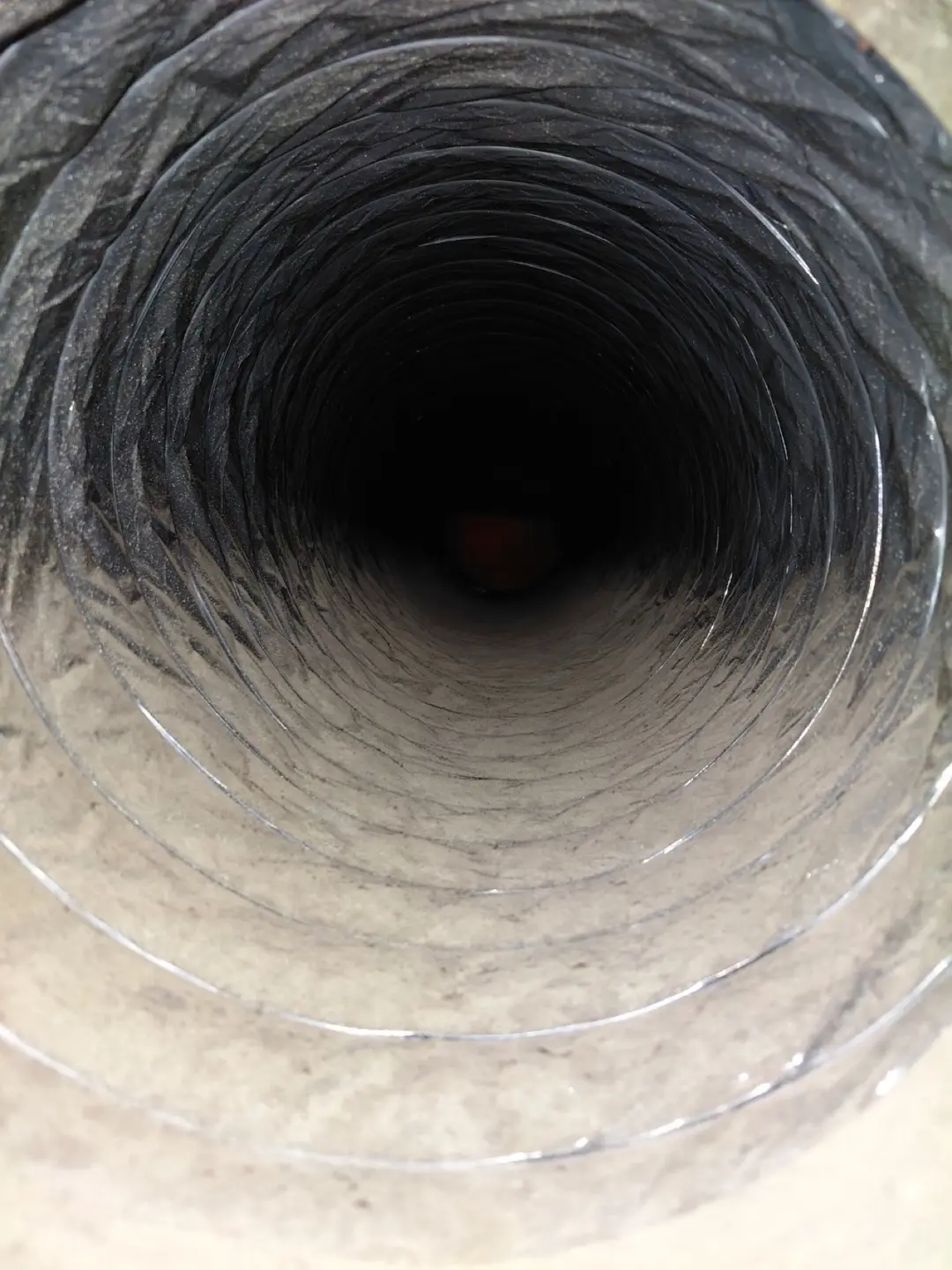 Inside of a dust-lined air duct before professional cleaning