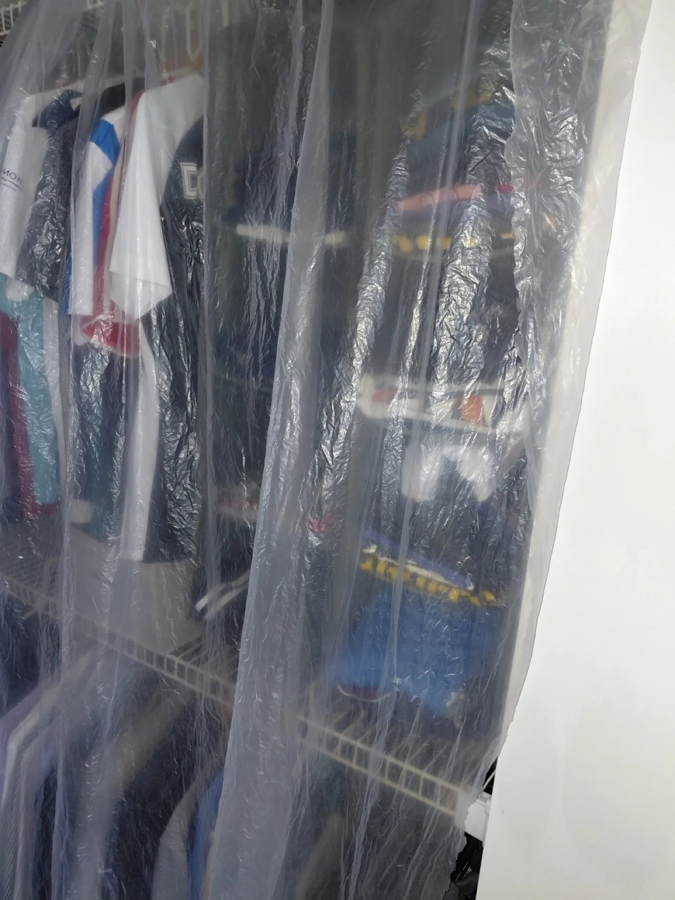 Home furniture and closet protected with plastic sheeting during duct cleaning