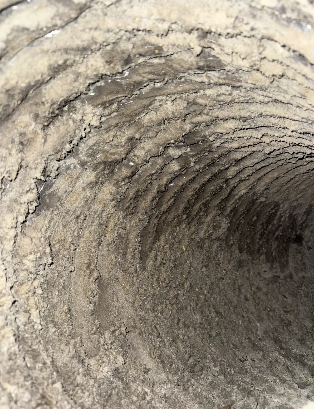 Inside of home air ducts coated in thick dust and grime — what we find in systems that were never cleaned